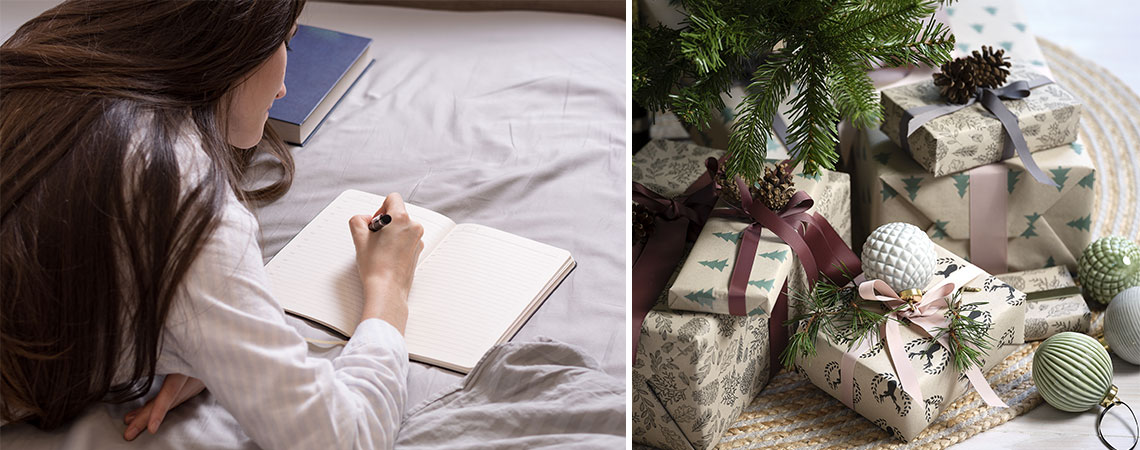 Femme allongée sur un lit en train d'écrire une liste de courses et cadeaux de Noël sous le sapin