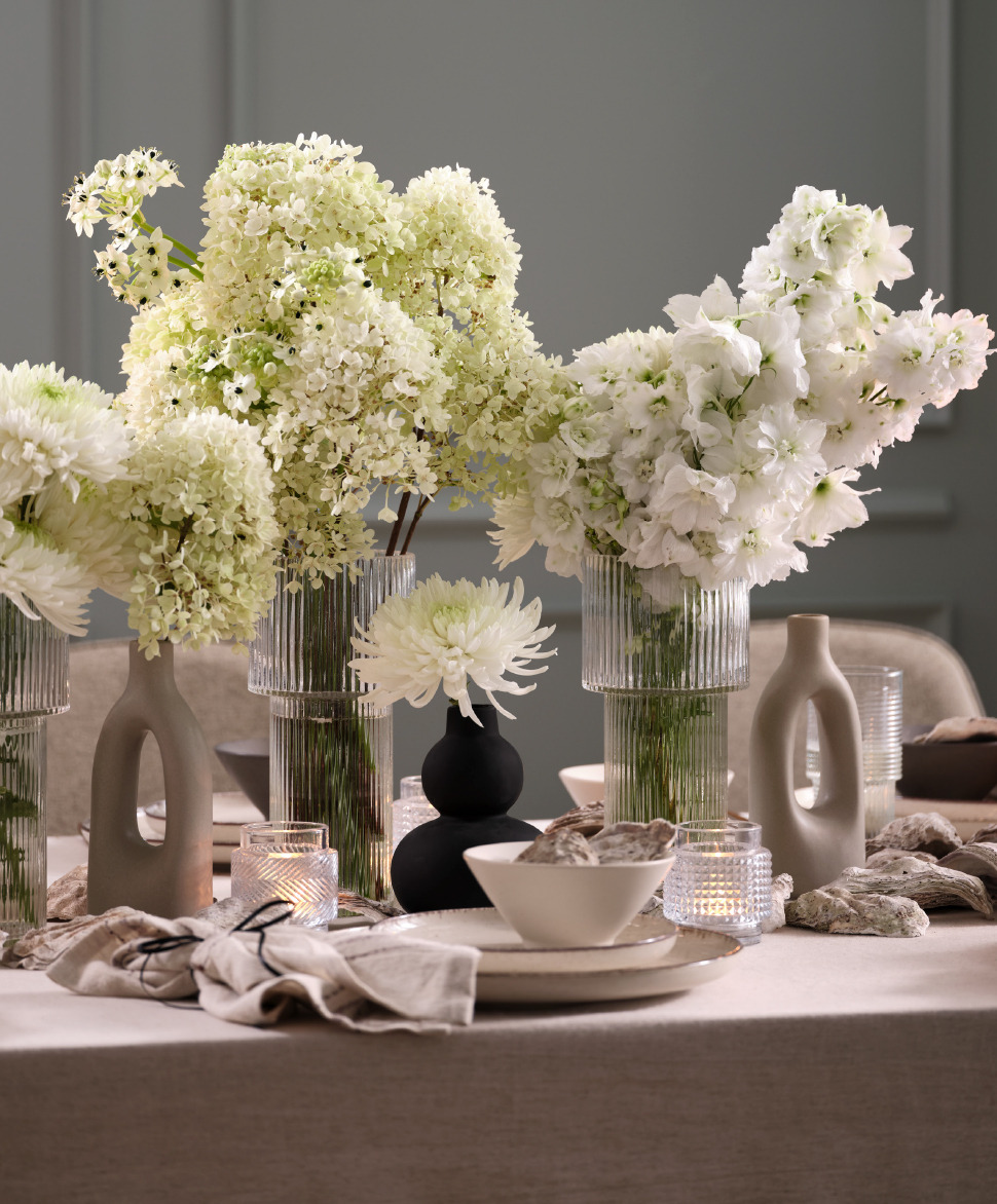 Arrangements floraux de hauteurs différentes pour décorer une table