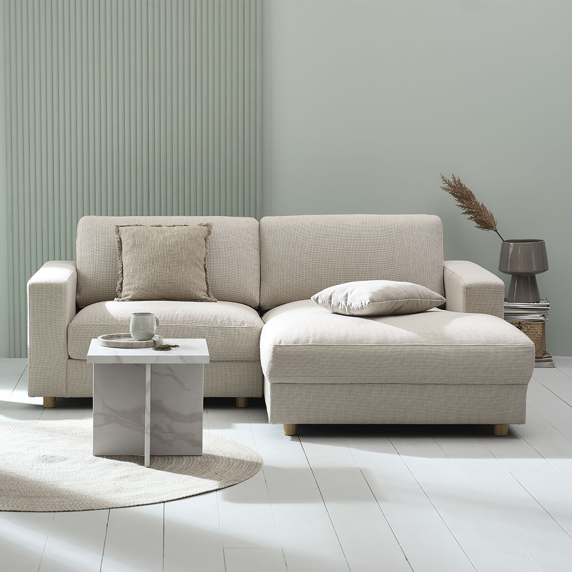 Beige 2-seater sofa with chaise lounge in a modern and minimalistic living area