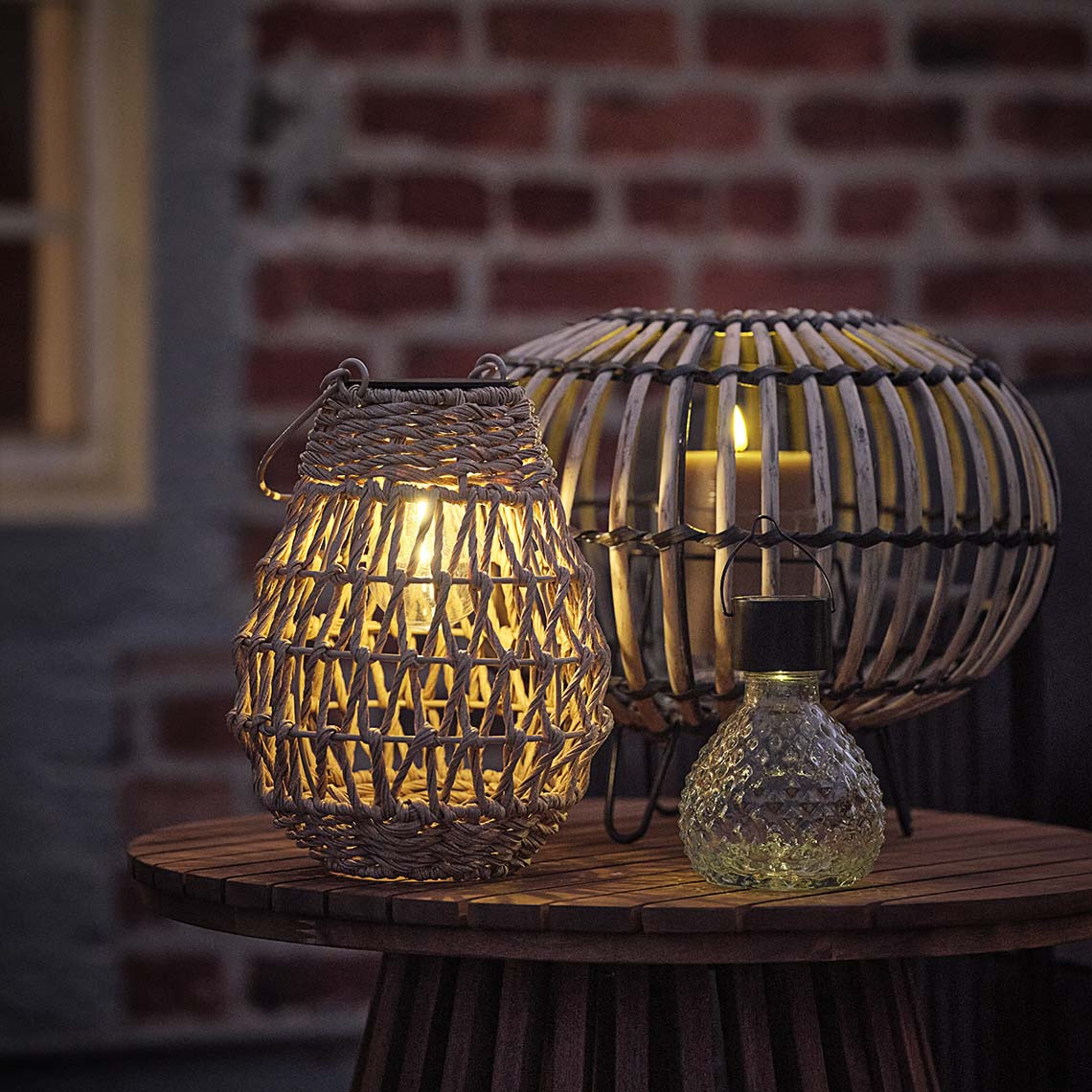 ENGHAUK lantern, LAPPSPURV solar lamp, and BREMSE battery lamp Outdoor lantern, solar lantern, and solar garden light emitting a warm light at night