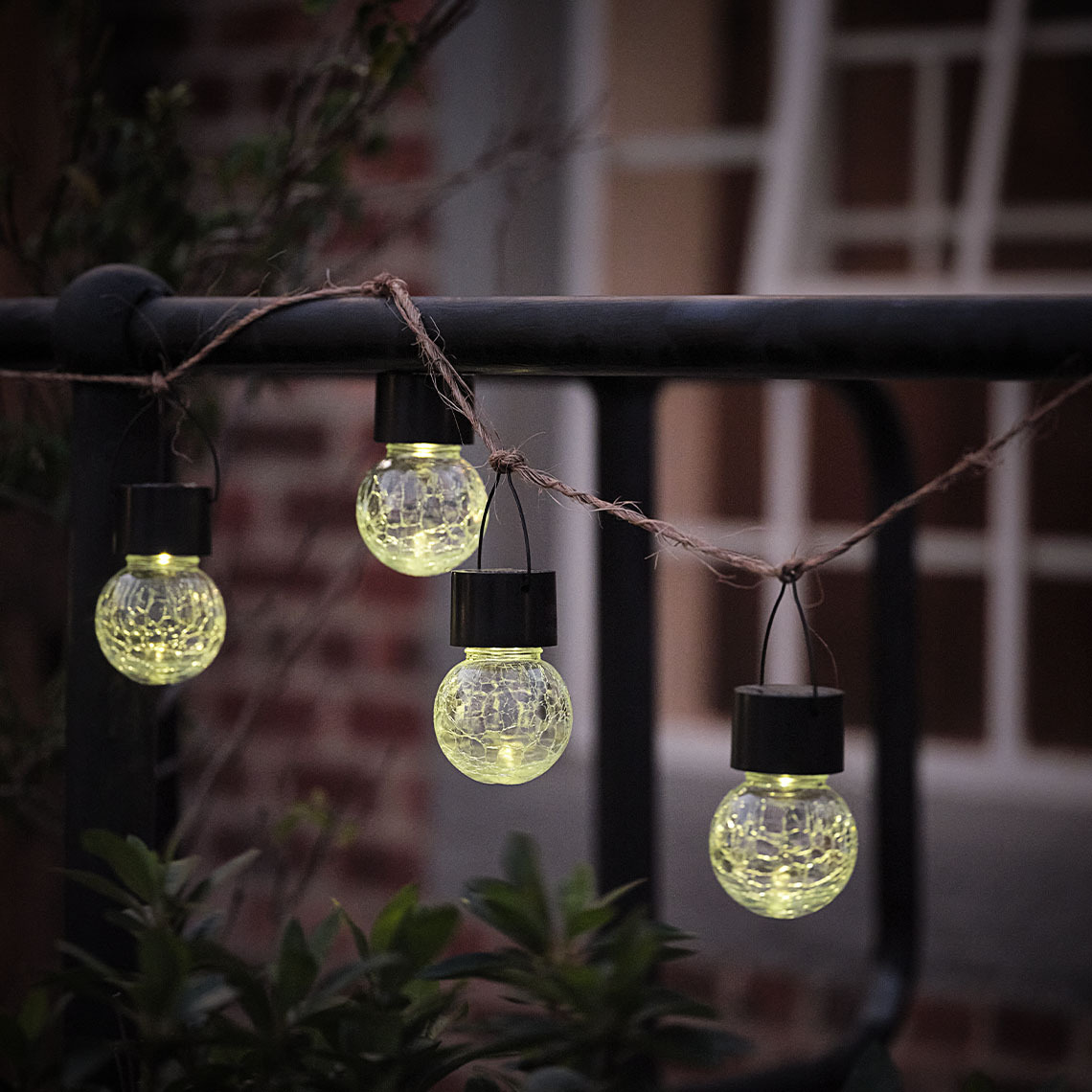 NATTERGAL solar lights Small solar garden light hung on a string along a fence