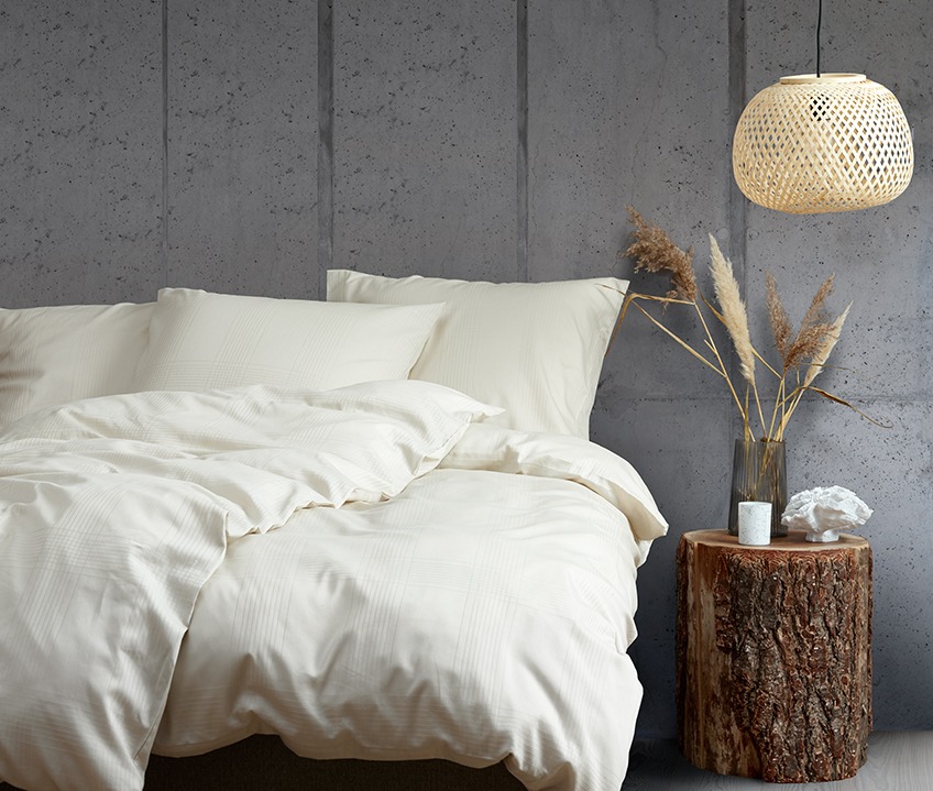 CILJE bed linen in sand with ROY vase, ANTON scented candle and TORLEK ornament Elegant bedroom with a calm Nordic look and bed made with sand coloured bedding