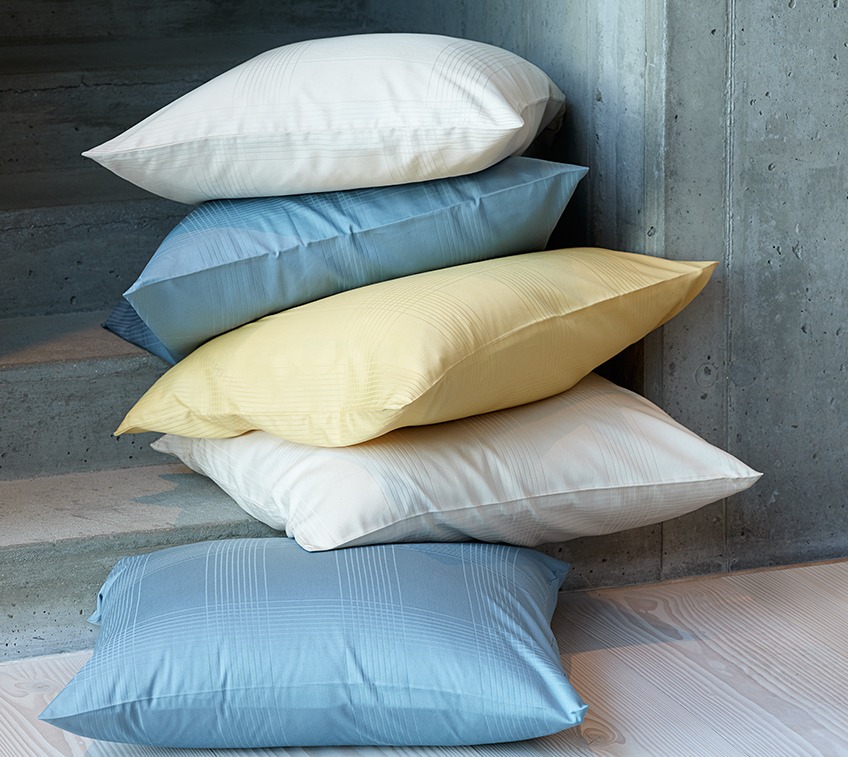 CILJE bed linen is available in petrol, sand and yellow Pile of pillows with covers on petrol, sand and yellow