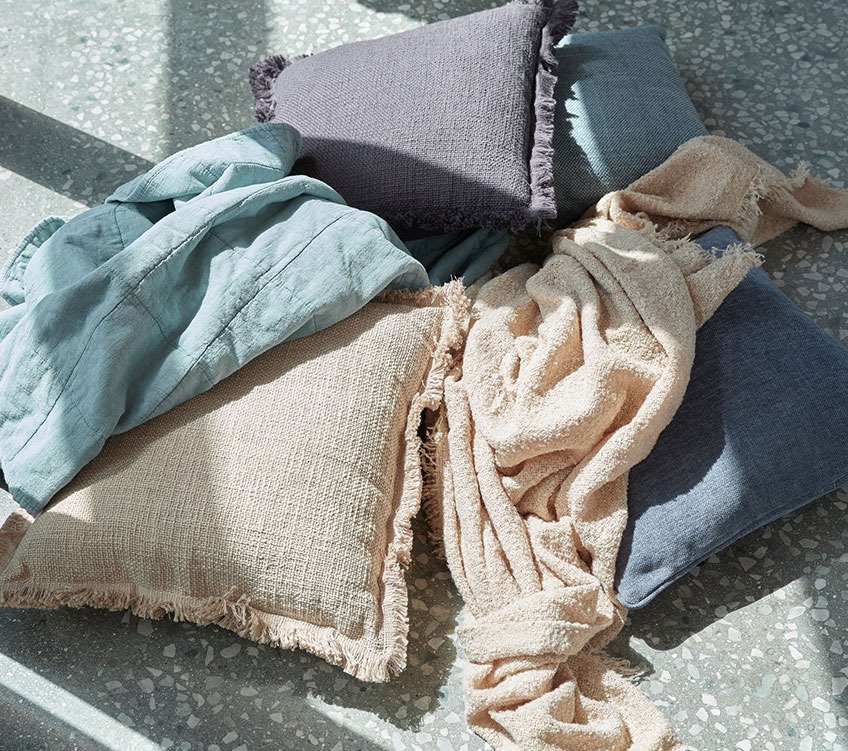 plaid bleu VALMUE, plaid beige ROSE, coussins HORTENTIA et HORNFIOL plaid bleu, plaid beige et coussins kaki et bleu au sol
