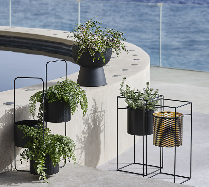 Pots de fleurs AND, MIDSOMMER, et LOMVI Pots de fleurs surélevés sur un balcon