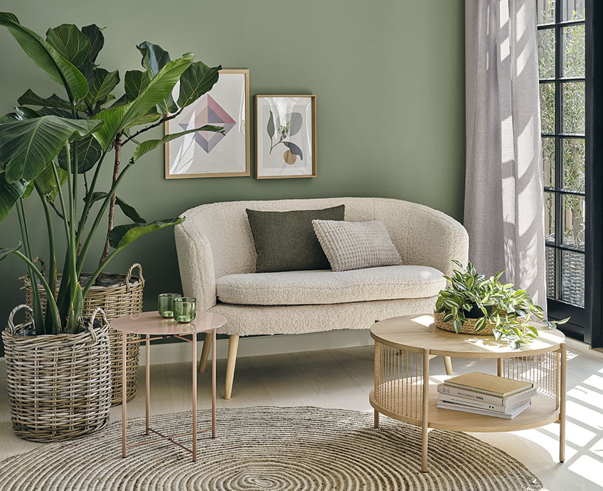 GISTRUP sofa, HORNSYLD end table and EGELEV coffee table Living room with white sofa, oak coffee table, and green plants